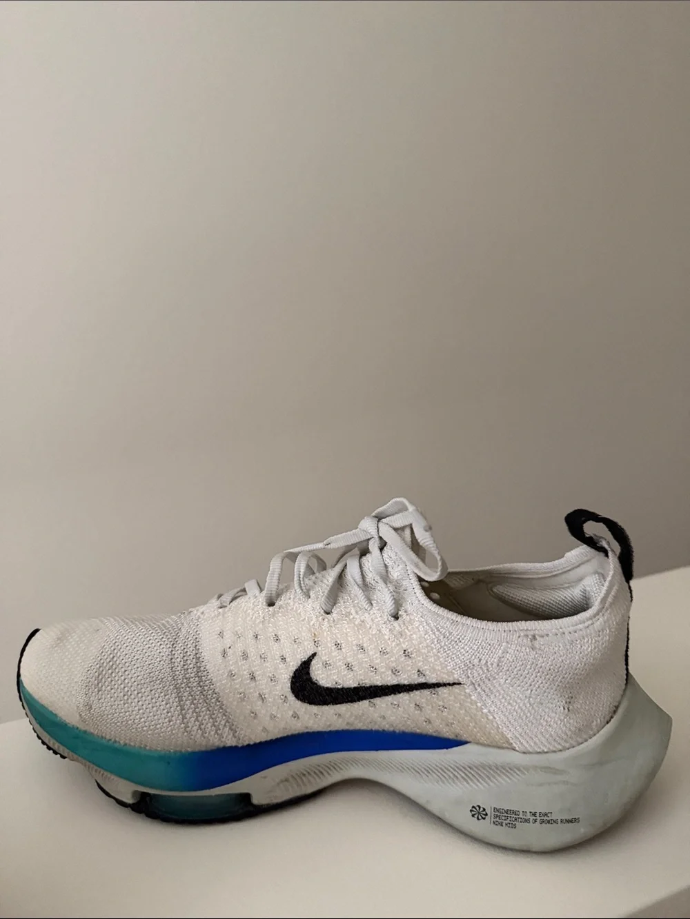 Nike White Running Shoes with Pink Accent and Black Swoosh